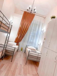 a bedroom with two bunk beds and a window at Hostel u Kmity in Krakow