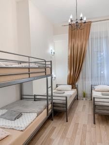 a bedroom with two bunk beds and a chandelier at Hostel u Kmity in Krakow