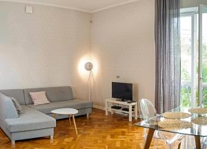 a living room with a couch and a table at Zoli Apartment in Warsaw