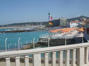 a beach with a bunch of umbrellas and the water at Piccolo Hotel in Rosignano Solvay