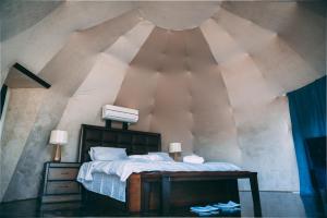 een slaapkamer met een groot bed op zolder bij Zeina Desert Lodge in Wadi Rum