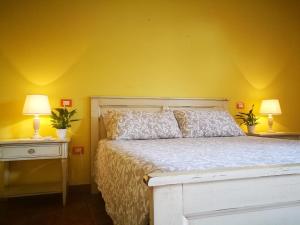 A bed or beds in a room at Masseria Borgo del Gallo