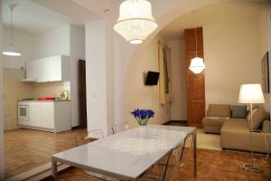 a kitchen and living room with a white table and chairs at casa Ada in SantʼAntìoco