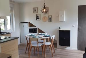 a kitchen and dining room with a table and chairs at CDG Aparts in Le Mesnil-Amelot