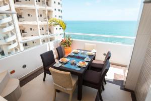 a dining room with a table and chairs and the ocean at Hotel Cabreromar in Cartagena de Indias +71 photos