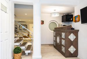 a staircase in a home with a white column at Ataraxy Hotel Boutique in San Andrés