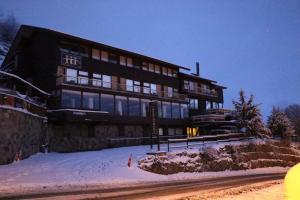 ein großes Gebäude im Schnee vor einer Straße in der Unterkunft Hotel HF in Farellones
