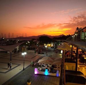 a group of tables and umbrellas on a patio at sunset at Casa Zen in Puerto Calero