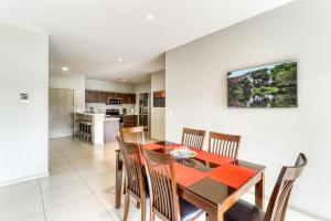 a dining room and kitchen with a table and chairs at Jaco Bay 2102 in Jacó