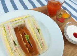 a sandwich on a white plate on a table at B&B Forest Shima in Shima