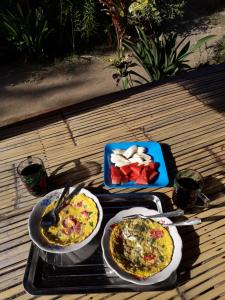 two trays of food sitting on a table at Crispycool Homestay in Kuta Lombok