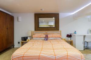 1 dormitorio con cama y espejo en la pared en Modern & homely comfort, en Vermont South