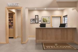 a waiting room with a welcome sign on the wall at Country Inn & Suites by Radisson, Fairborn South, OH in Fairborn