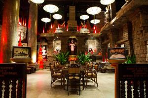 a dining room with tables and chairs in a building at Hotel Tugu Malang in Malang