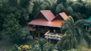 an overhead view of a house with a person standing on the porch at Huensala Homestay in Ban Wang Khon