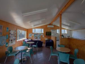 
a dining room with tables, chairs, and tables at Alpine-Pacific Holiday Park in Kaikoura
