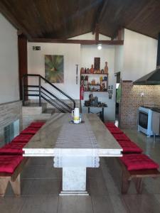 a large table with red cushions in a room at Sefiroh Hostel in Viçosa