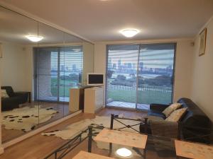 a living room with a couch and a large window at Apartment with a View in Perth