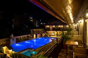 a swimming pool on the roof of a building at night at Busy Bee Resort, Pokhara in Pokhara