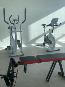 two exercise bikes in a gym with a treadmill at The Sassy House in Pantai Cenang