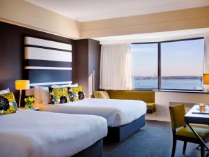 Postel nebo postele na pokoji v ubytování Mövenpick Hotel Auckland