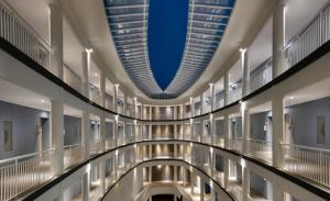 a long hallway of a building with a blue ceiling at Novus Jiva Anyer in Anyer