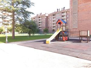 a playground with a slide in a park at VUT Olimpia in Jaca