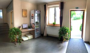 a room with a refrigerator and a window at Penzion Na Bobrovníku in Lipova Lazne