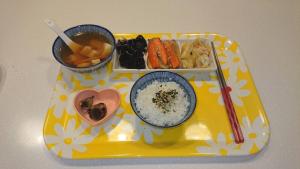 a tray of food with rice and vegetables and chopsticks at 500Km Home in Hualien City