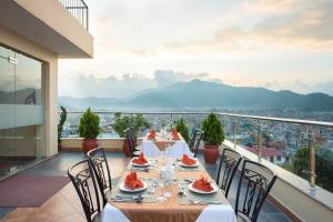 a table on a balcony with a view of a city at Hotel Moonlight in Kathmandu