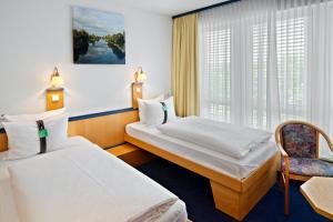 Hotel Leipzig-Günthersdorf tesisinde bir odada yatak veya yataklar