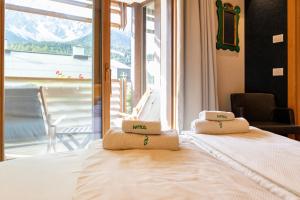 a bedroom with a bed with two pillows on it at Residence Intica in San Candido