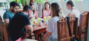 a group of people sitting around a table at SURF & SAND Hotel Arugambay in Arugam Bay