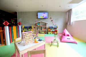 a childs room with a toy store and a tv at Furama Silom Hotel in Bangkok