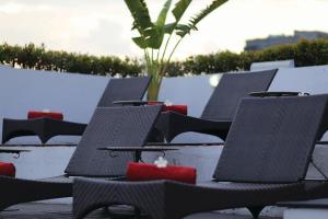 a row of chairs sitting on top of a beach at Furama Silom Hotel in Bangkok