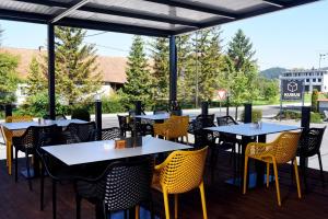 a row of tables and chairs on a patio at Guesthouse KUBUS in Ljubljana