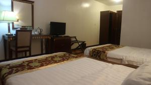 Uma cama ou camas num quarto em Excelsior Resort