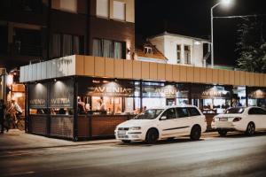 a white van parked in front of a store at Avenia in Ruma