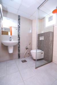 a bathroom with a shower and a toilet and a sink at ماجيك سويت ابوحليفة Magic Suite Abu Halifa in Kuwait