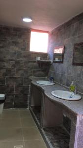 
a bathroom with a sink, toilet and mirror at Bedouin Roads in Wadi Rum
