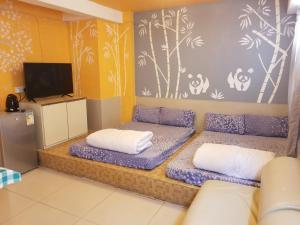 una camera con due letti e una TV a schermo piatto di Silverview Resort Holiday a Hong Kong