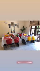 a dining room with tables and yellow chairs at The Neem in New Delhi