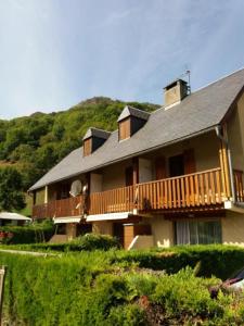 a large house with a deck on a hill at Gite Prat de sempé in Vignec