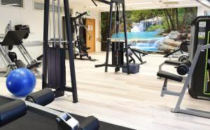 a gym with a waterfall in the background at Finlandia Hotel Aquarius in Uusikaupunki