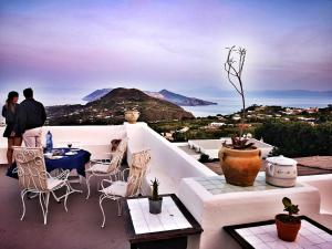 a group of people standing on a balcony looking at the ocean at Villa Paradiso in Piano Conte