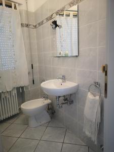 a bathroom with a sink and a toilet at Sul Confine in Cervia