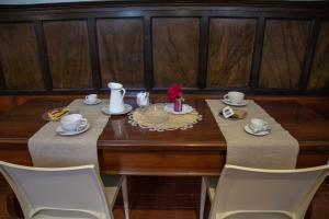 a dining room table with two chairs and a table with at Convento San Bernardino in Montefranco