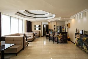 a large living room with couches and tables and a room with at Hotel Alex in Galaţi