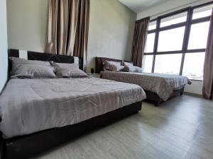 a bedroom with two beds and a large window at Mykey Atlantis D-08-05 Melaka City Swimming pool close in Malacca
