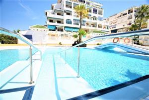 a swimming pool in front of a building at 52 Luxury Pool - AC/WIFI in La Mata